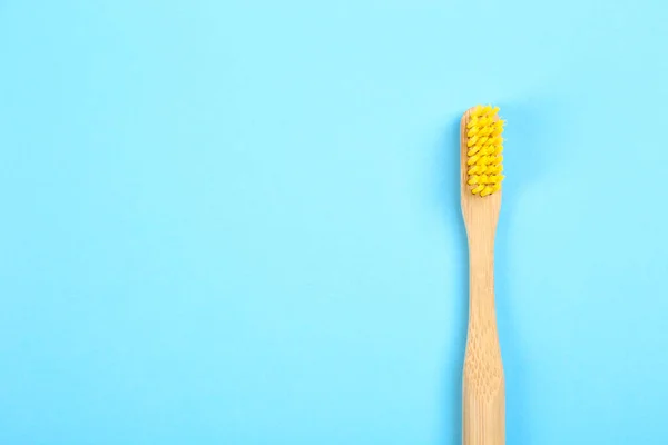 Toothbrush made of bamboo on light blue background, top view. Sp — 스톡 사진