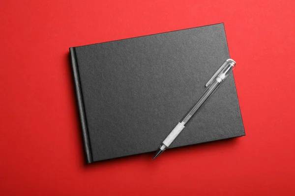 Stylish Black Notebook Pen Red Background Top View — Stock Photo, Image