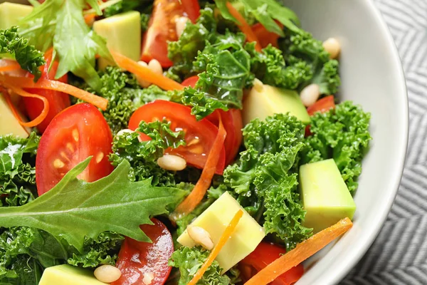 Tasty fresh kale salad on table, closeup