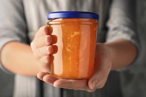 Woman with jar of orange jam, closeup — Stock Photo, Image