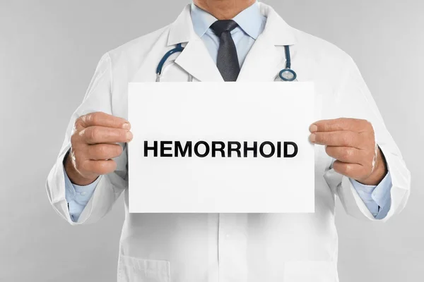 医師のサインを持っている単語Hemorroidライトグレーの背景に クローズアップ — ストック写真