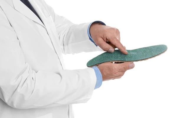 Male orthopedist showing insole on white background, closeup — Stock Photo, Image
