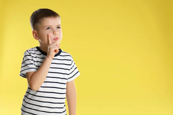 Portrait of little boy on yellow background. Space for text — 스톡 사진