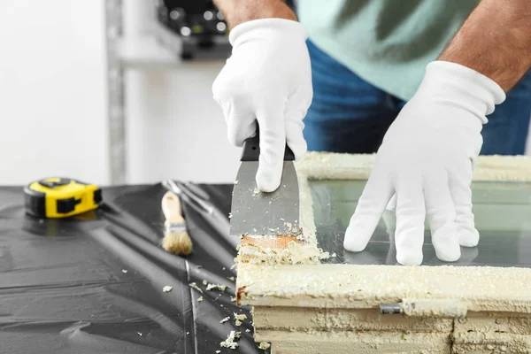 Man repairing old damaged window at table indoors, closeup — 스톡 사진