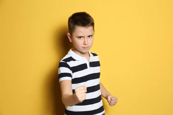 Portrait of emotional preteen boy on yellow background — 스톡 사진