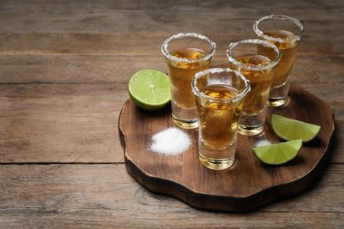 Meksika tekilası, kireç ve tuz ahşap masada.