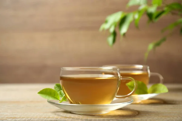 Cups Green Tea Leaves Wooden Table — 스톡 사진