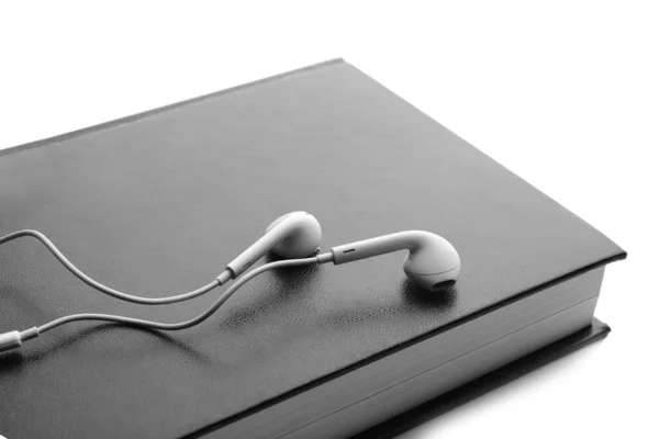 Bible and earphones on white background, closeup. Religious audi — Stock Photo, Image