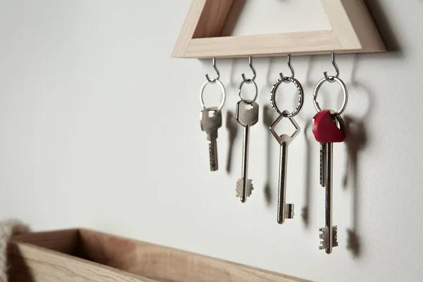 Wooden key holder on light wall indoors. Space for text — 스톡 사진