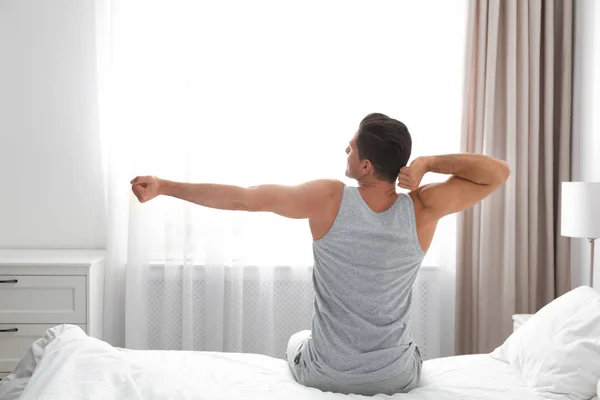 Homem acordando na cama em casa. Manhã preguiçosa — Fotografia de Stock