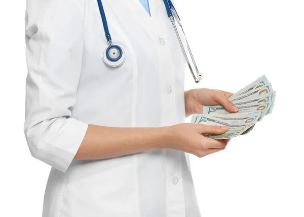 Doctor with bribe on white background, closeup. Corruption in me — Stock Photo, Image