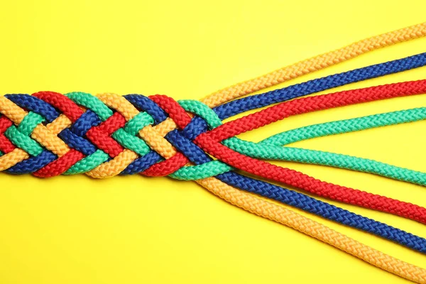 Braided Colorful Ropes Yellow Background Top View Unity Concept — 스톡 사진