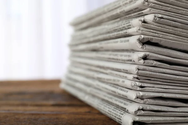 Stack of newspapers on wooden table, space for text. Journalist' — Stock fotografie