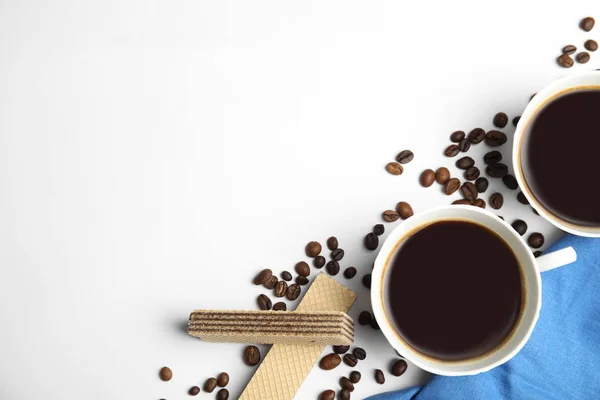 Breakfast with delicious wafers and coffee on white background, flat lay. Space for text