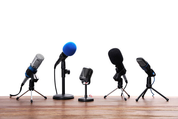 Set of different microphones on wooden table. Journalist's equip