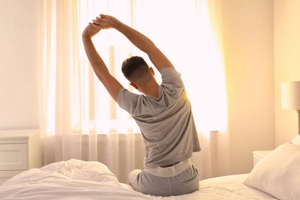 Young Man Stretching Bed Home View Back Lazy Morning — Stock Photo, Image