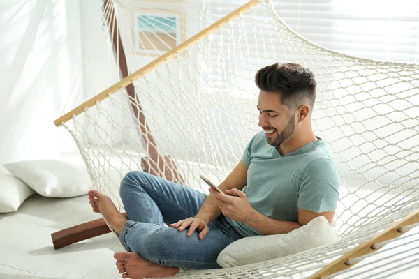 Young Man Using Smartphone Hammock Home — 스톡 사진