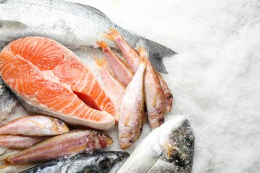 Taze balık ve buzda deniz ürünleri, düz uzanmış.