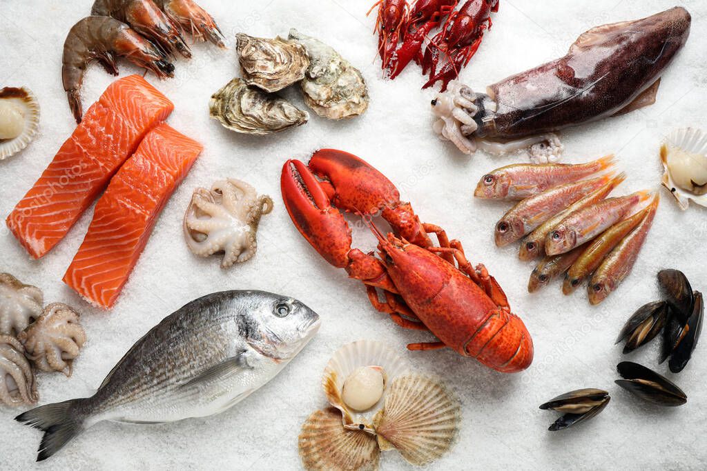 Fresh fish and seafood on ice, flat lay