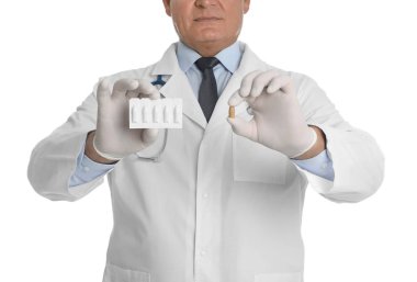 Doctor holding suppositories for hemorrhoid treatment on white background, closeup clipart