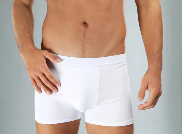 Man in white underwear on light grey background, closeup — Stock Photo, Image