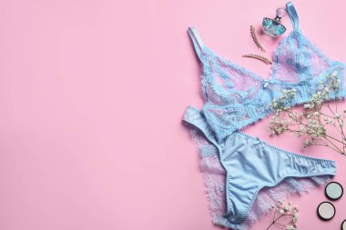 Flat lay composition with women's underwear and space for text on pink background