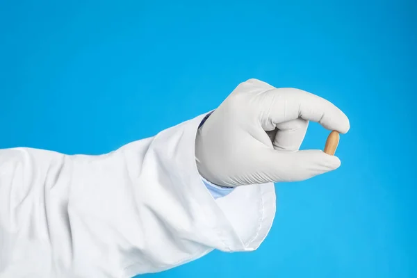 Arzt Hält Zäpfchen Zur Behandlung Von Hämorrhoiden Auf Blauem Hintergrund — Stockfoto