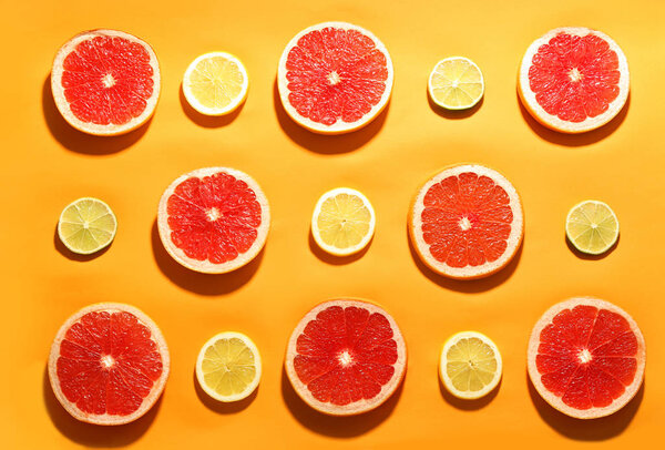 Flat lay composition with tasty ripe grapefruit slices on orange