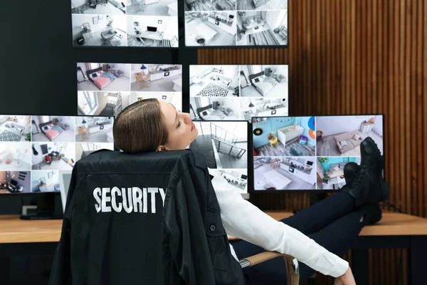 Tired security guard sleeping at workplace in office — Stock Photo, Image