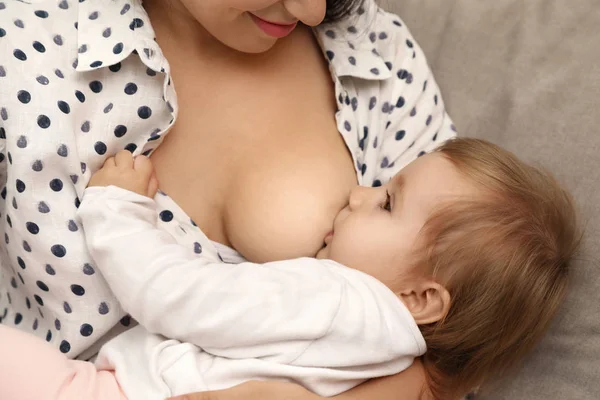 Woman breastfeeding her little baby at home, closeup — Stock Photo, Image