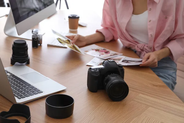 Professional photographer working at table in office, closeup