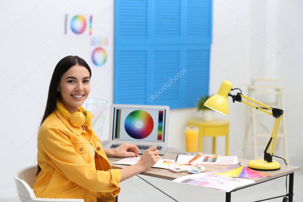 Female designer working at desk in office