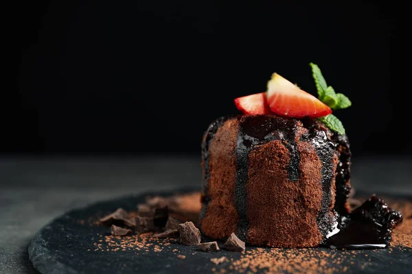 Delicious warm chocolate lava cake on slate board, closeup. Space for text