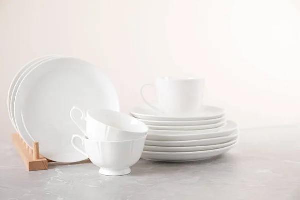 Set of clean tableware on light grey marble table — 스톡 사진