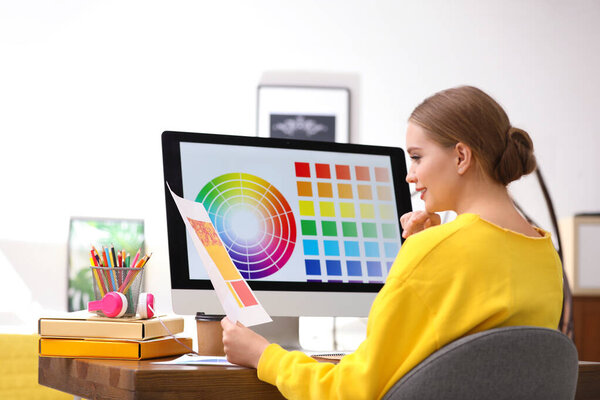 Professional designer working with computer at table in office