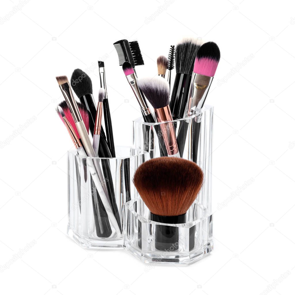 Set of professional makeup brushes on white background