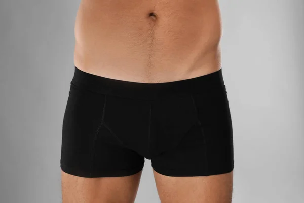 Man in black underwear on light grey background, closeup — Stok fotoğraf