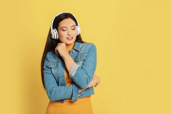 Young Woman Listening Audiobook Yellow Background Space Text — 스톡 사진