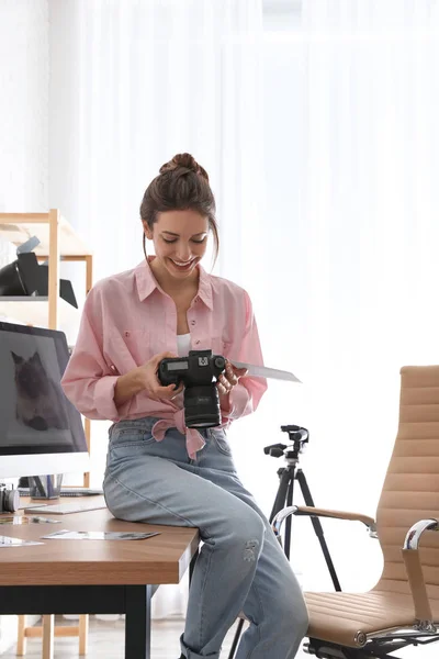 Professional photographer with camera working in light modern office