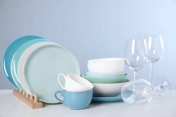 Set of clean tableware on light table — Stock Photo, Image