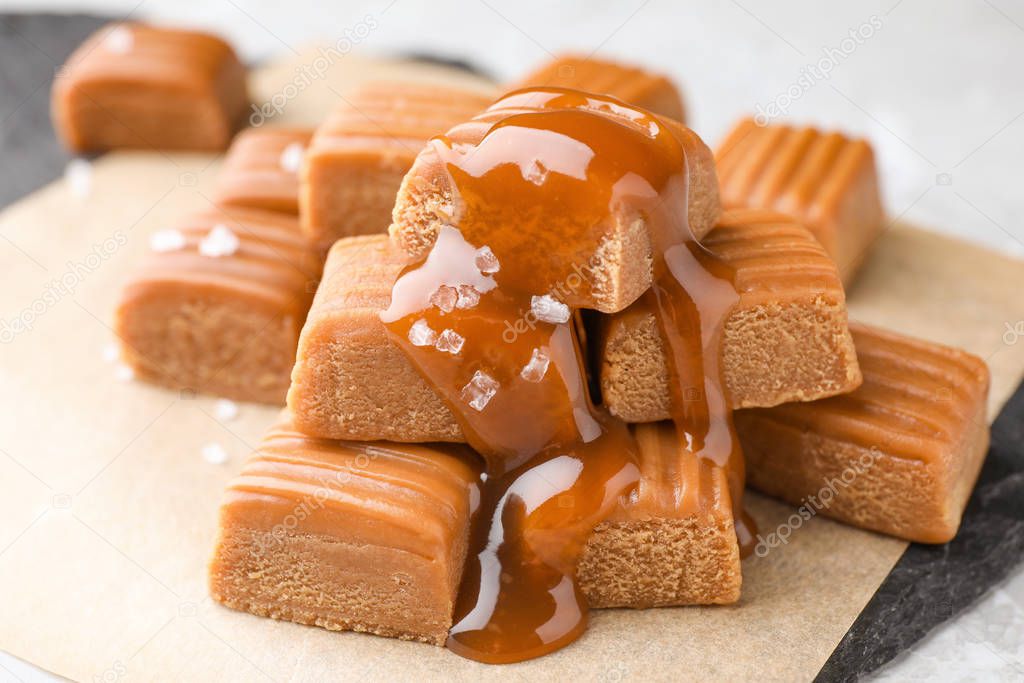Delicious salted caramel on parchment, closeup view
