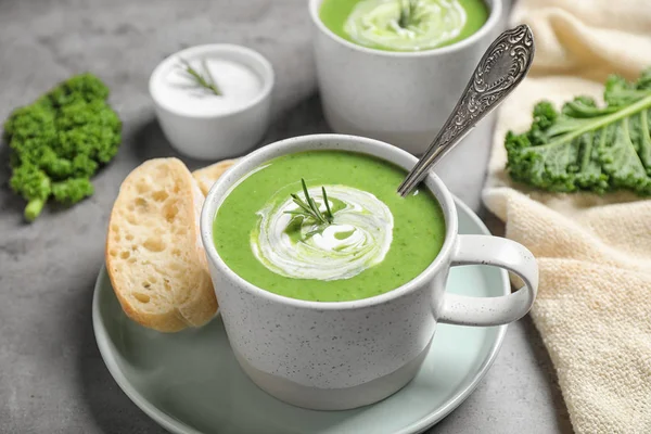 Tasty kale soup served on grey table, closeup — Stock Photo, Image