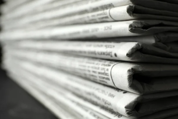 Stack of newspapers on table, closeup. Journalist\'s work