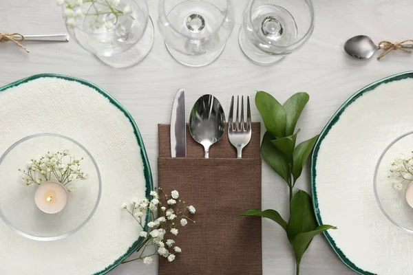 Elegant table setting with green plants on white wooden backgrou — 스톡 사진