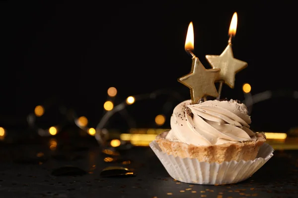 Cupcake with sparkling candle for 39th birthday or anniversary with big  number in white with yellow streamers on blue table with dark background  full Stock Photo - Alamy