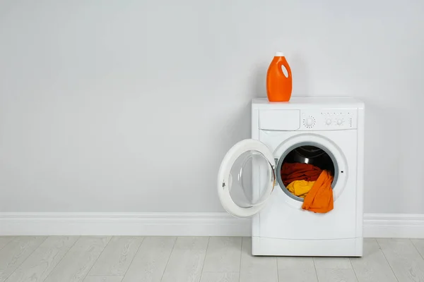 Machine à laver moderne avec buanderie et détergent près de White Wal — Photo