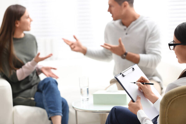 Professional psychologist working with couple in office