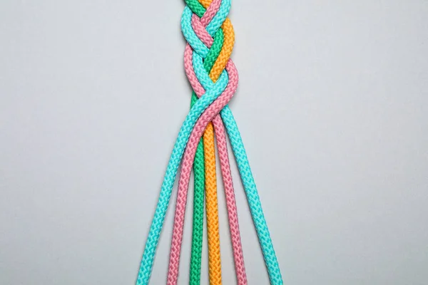 Braided Colorful Ropes Light Grey Background Top View Unity Concept — 스톡 사진