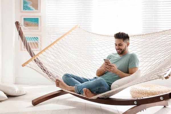 Young Man Using Smartphone Hammock Home — 스톡 사진