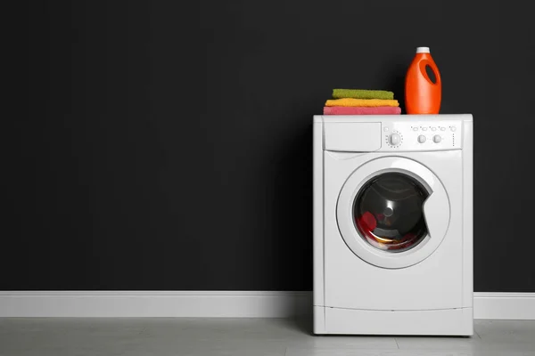 Modern washing machine with laundry, stack of towels and deterge — 스톡 사진
